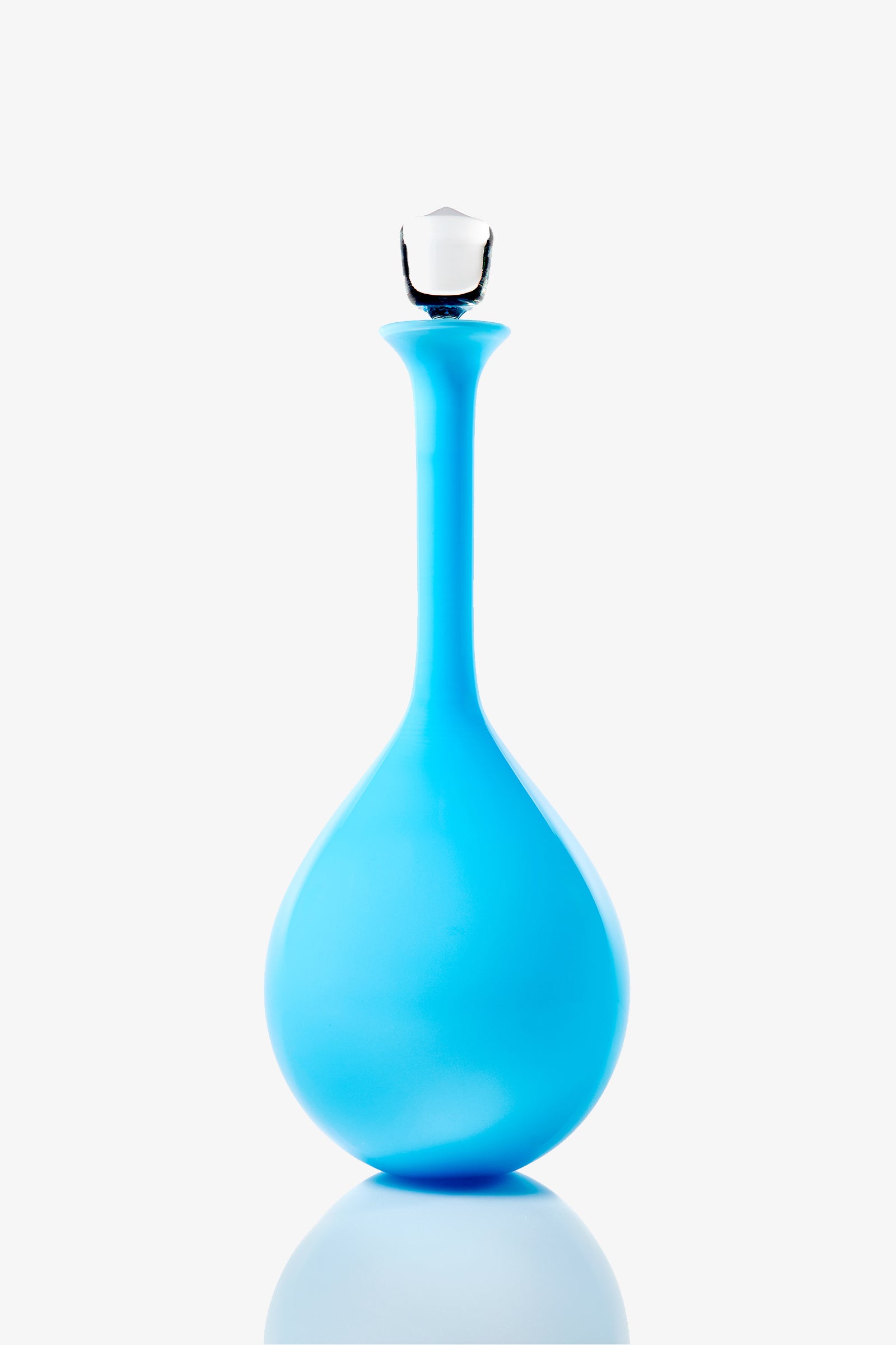 A Wexler Tear Drop Bottle, featuring a tall, narrow neck and a round base in bright blue glass, topped with a clear glass stopper and displayed against a plain white background.
