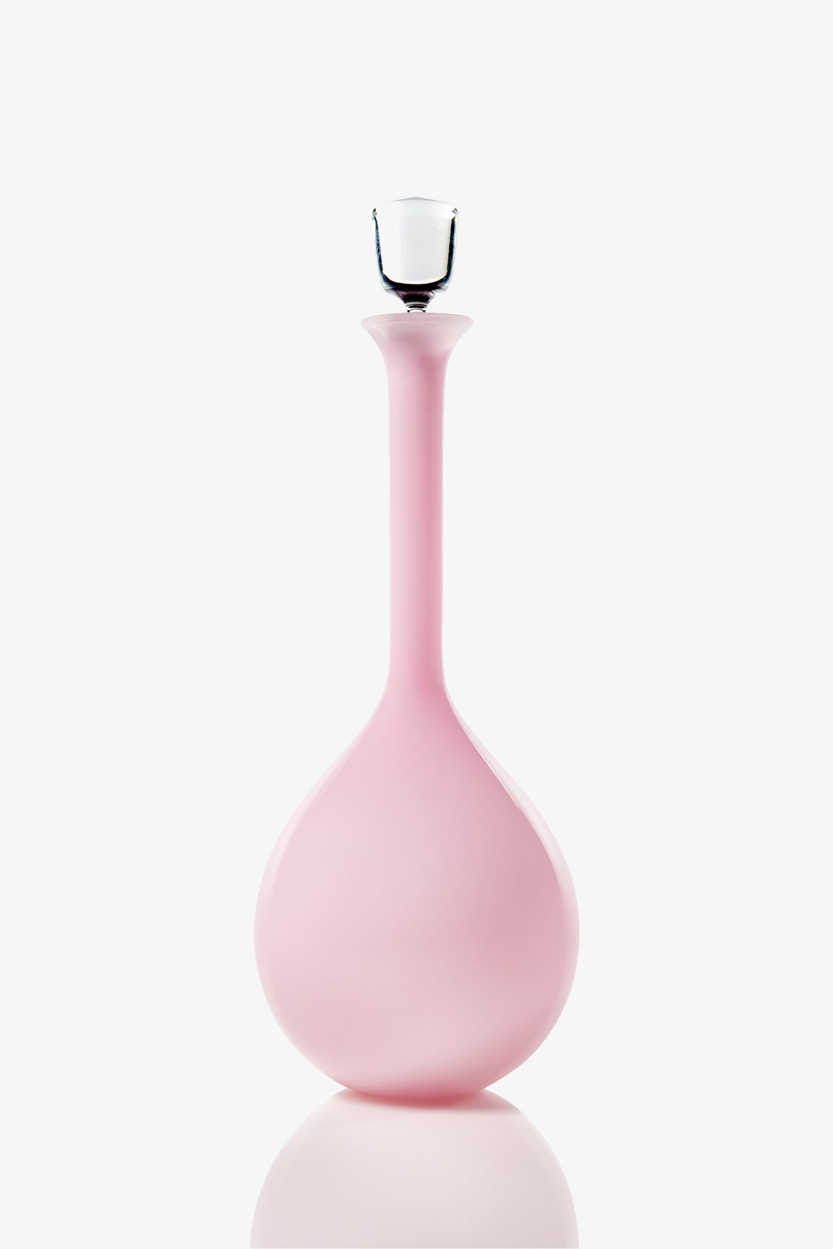A tall, elegant Wexler Tear Drop Bottle featuring pink glass with a round base and long neck, finished with a clear glass stopper, photographed against a plain white background.