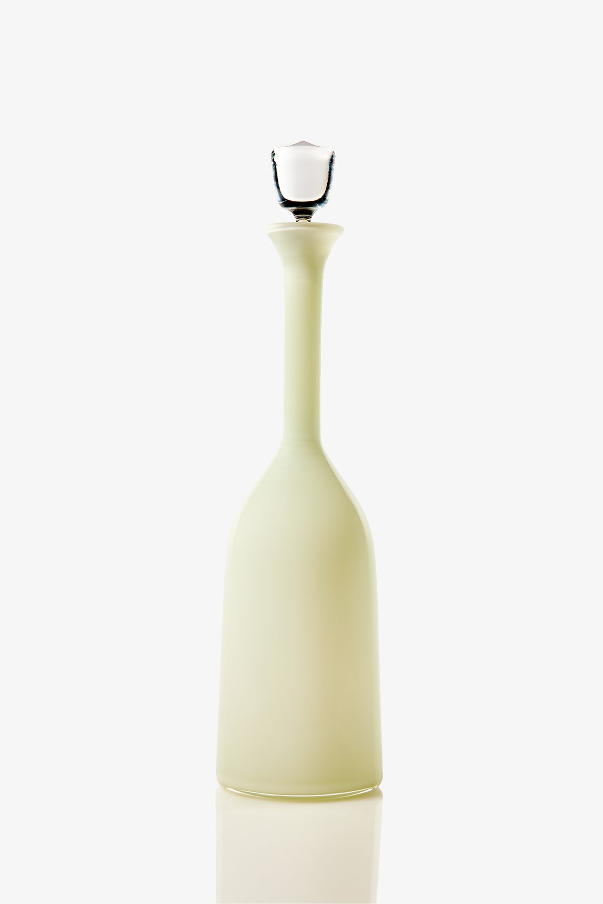 A tall, elegant Wexler Wide Bottle in pale yellow glass with a narrow neck and a white stopper, photographed against a white background.