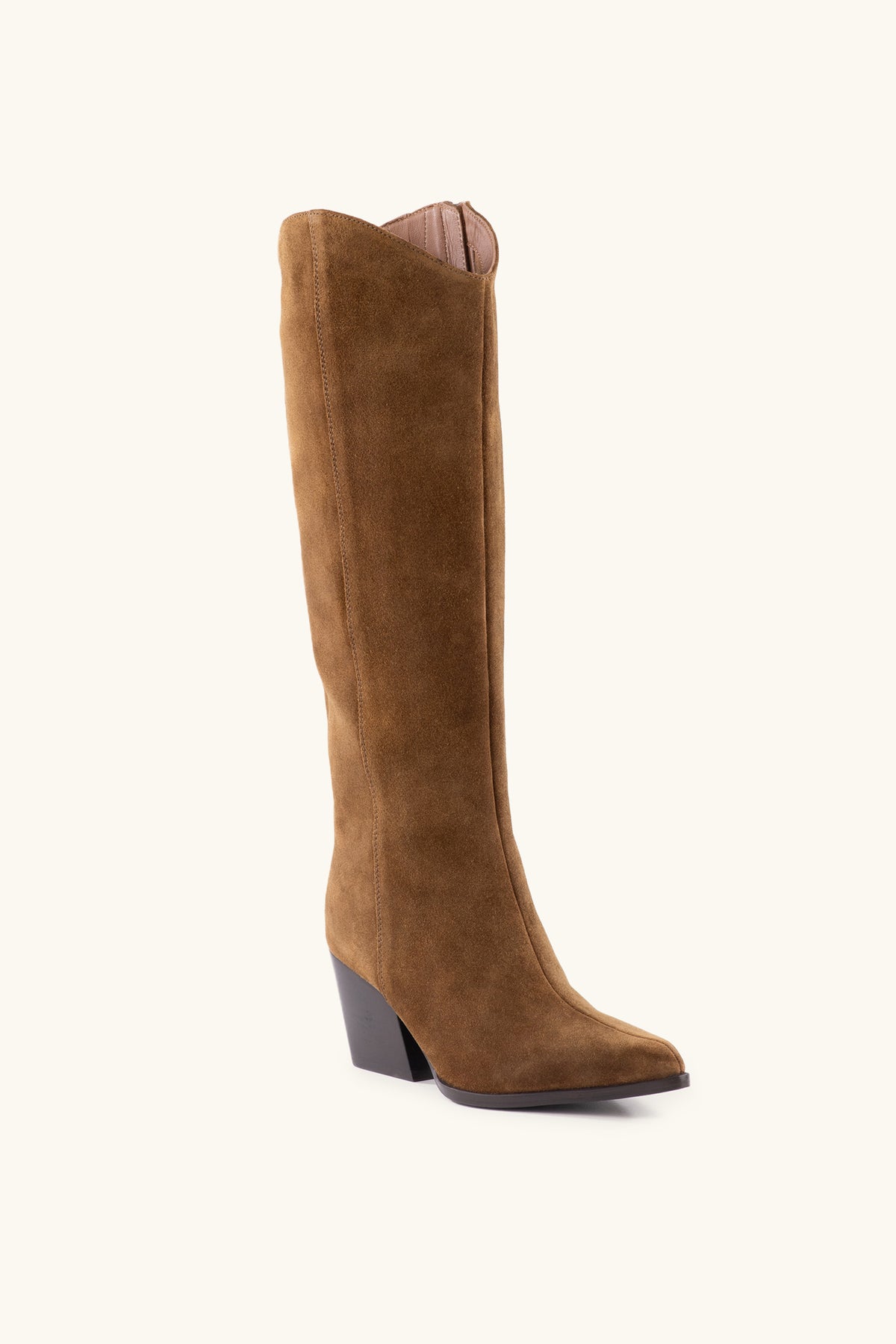 The Begging You Tall Brown Suede Boot features a pointed toe and stacked block heel, shown against an off-white background.