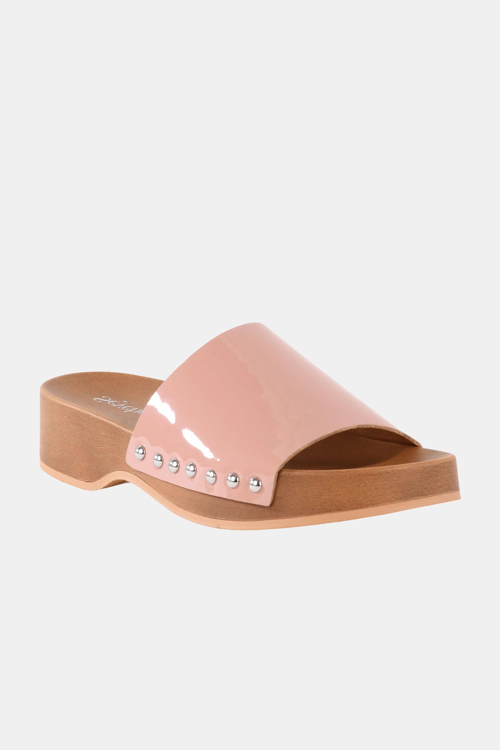 The Seychelles Fantasy Patnt Slide features a single glossy nude pink wide strap with small silver studs on the side, set atop a light wooden sole and a low chunky heel.