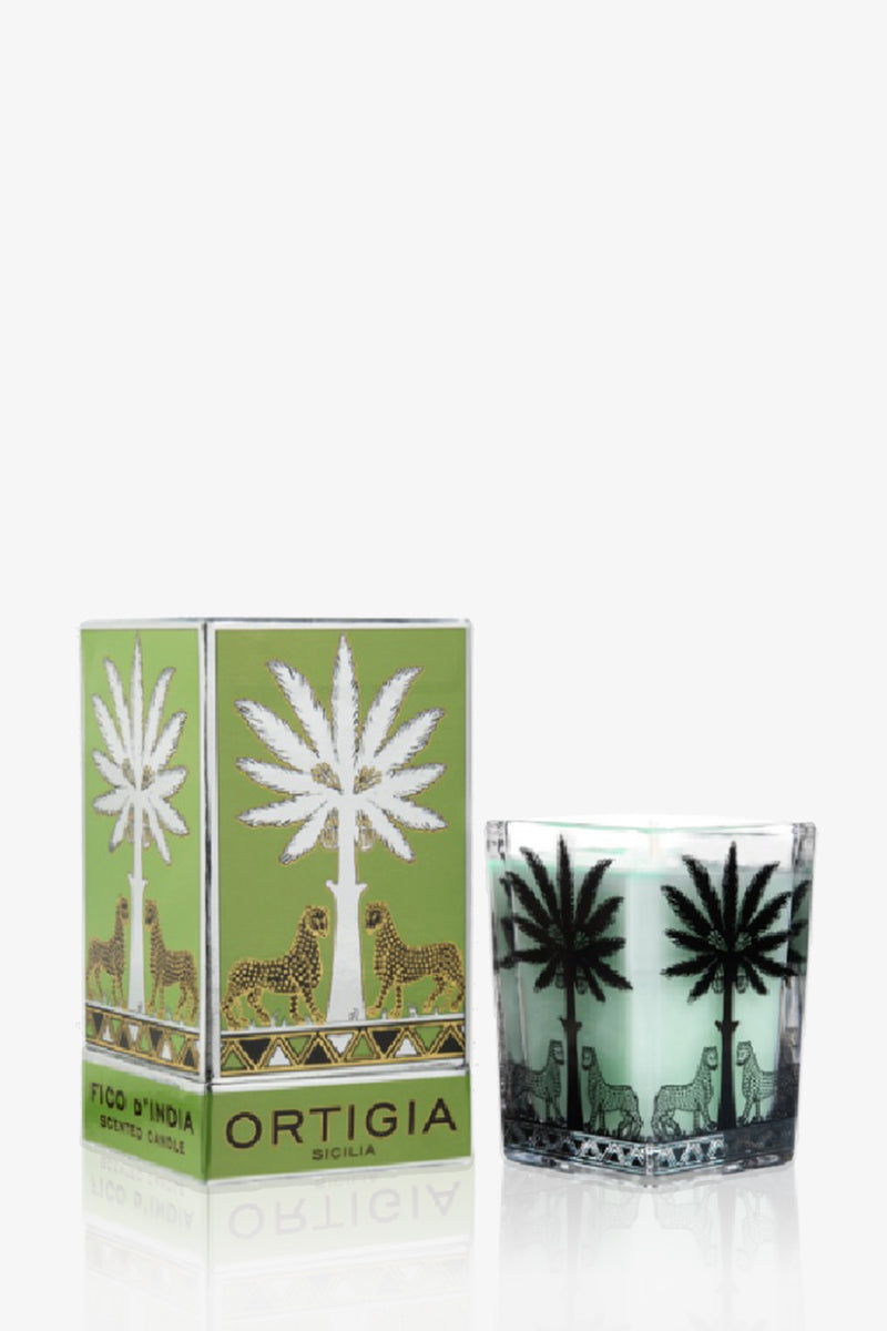 An Ortigia Candle Large Square in green, presented with a matching box, both featuring black palm tree and gold leopard designs on a light green background.