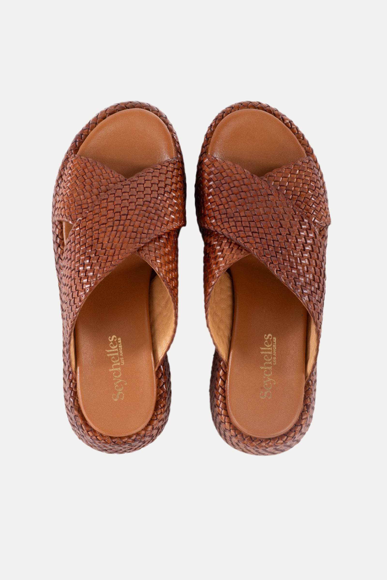 A pair of Key West Woven Leather Platform Slide Sandals in brown with crisscross woven straps, shown from above on a white background. The tan insole features the Sugarulls branding.