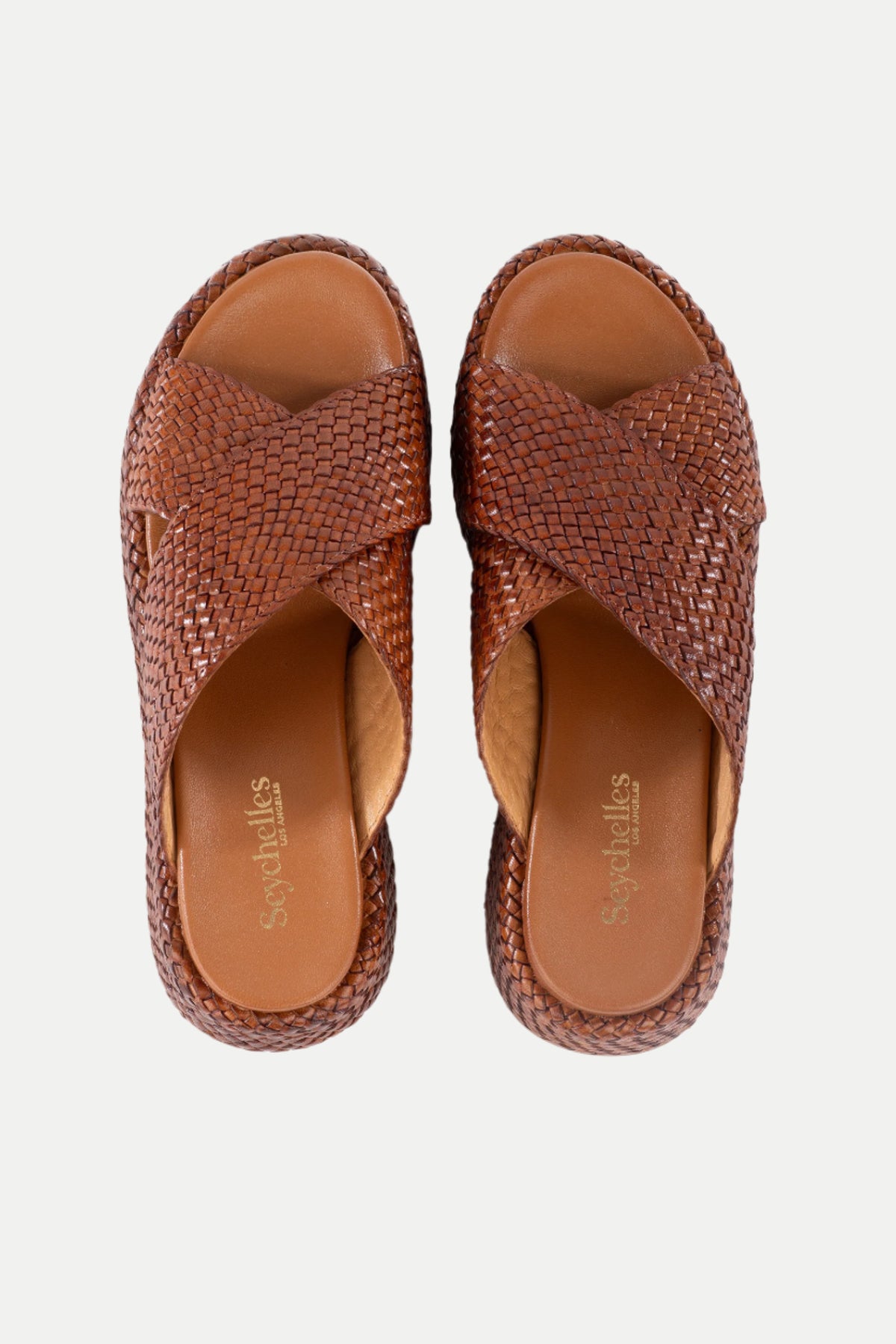 A pair of Key West Woven Leather Platform Slide Sandals in brown with crisscross woven straps, shown from above on a white background. The tan insole features the Sugarulls branding.