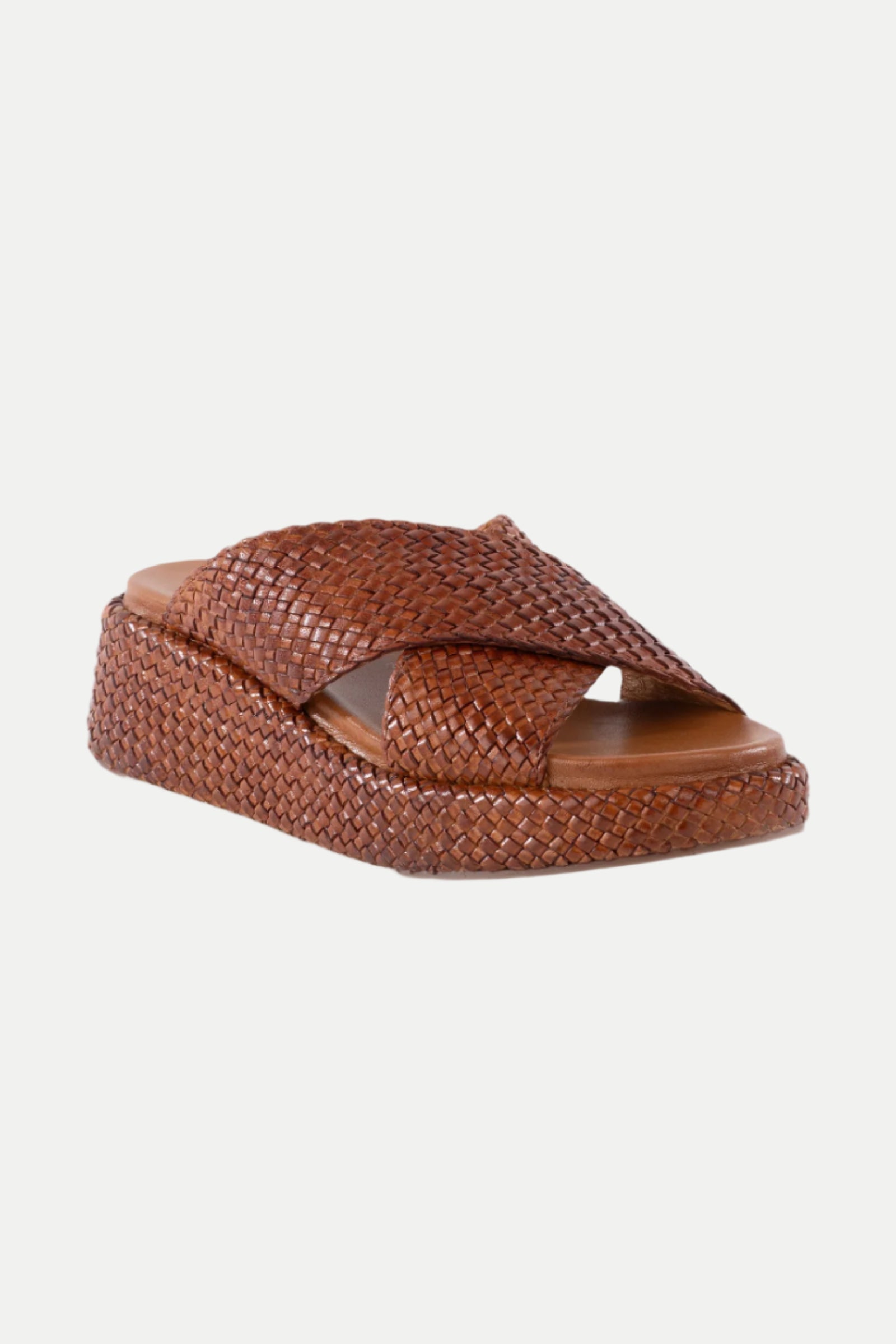 Key West Woven Leather Platform Slide Sandals feature wide crisscross straps, an open toe, and a textured braided design with a thick sole, shown on a white background.