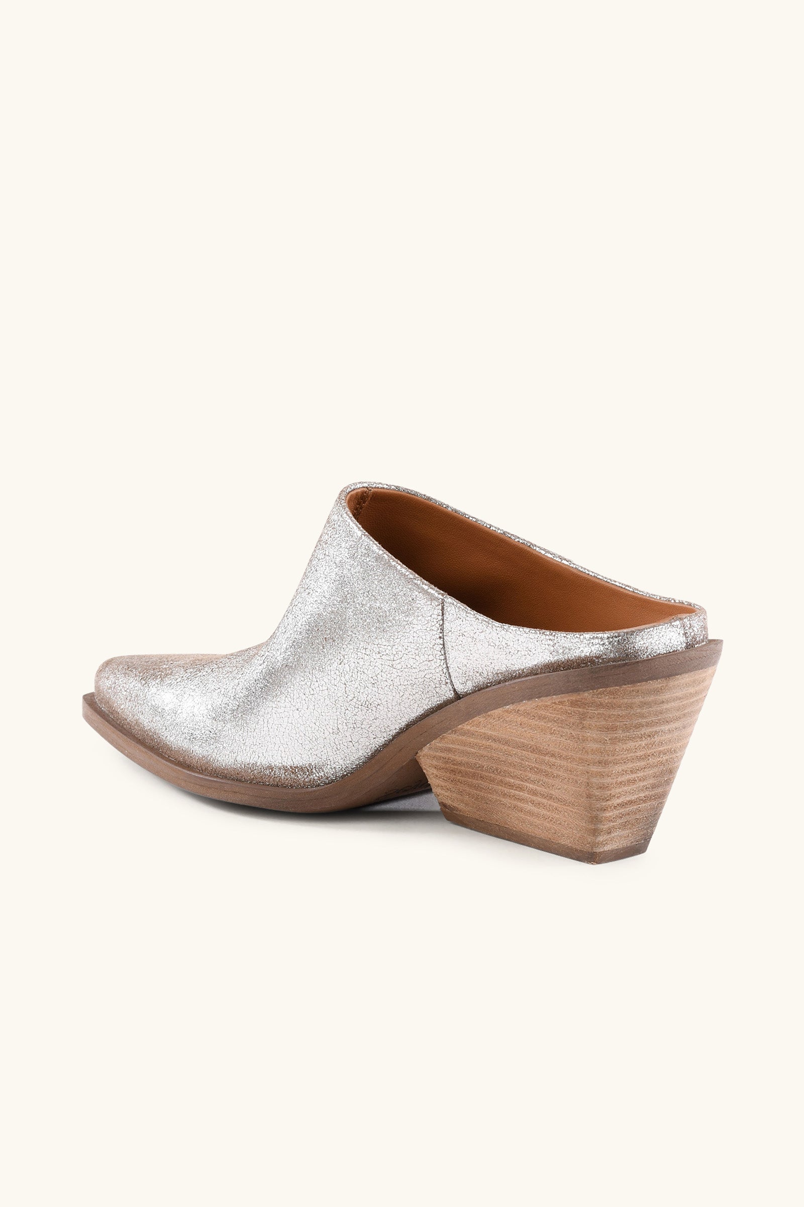 The Seychelles Morning Joe Mule is a silver, slip-on mule with a pointed toe and chunky, angled wooden heel, displayed against a plain light background.
