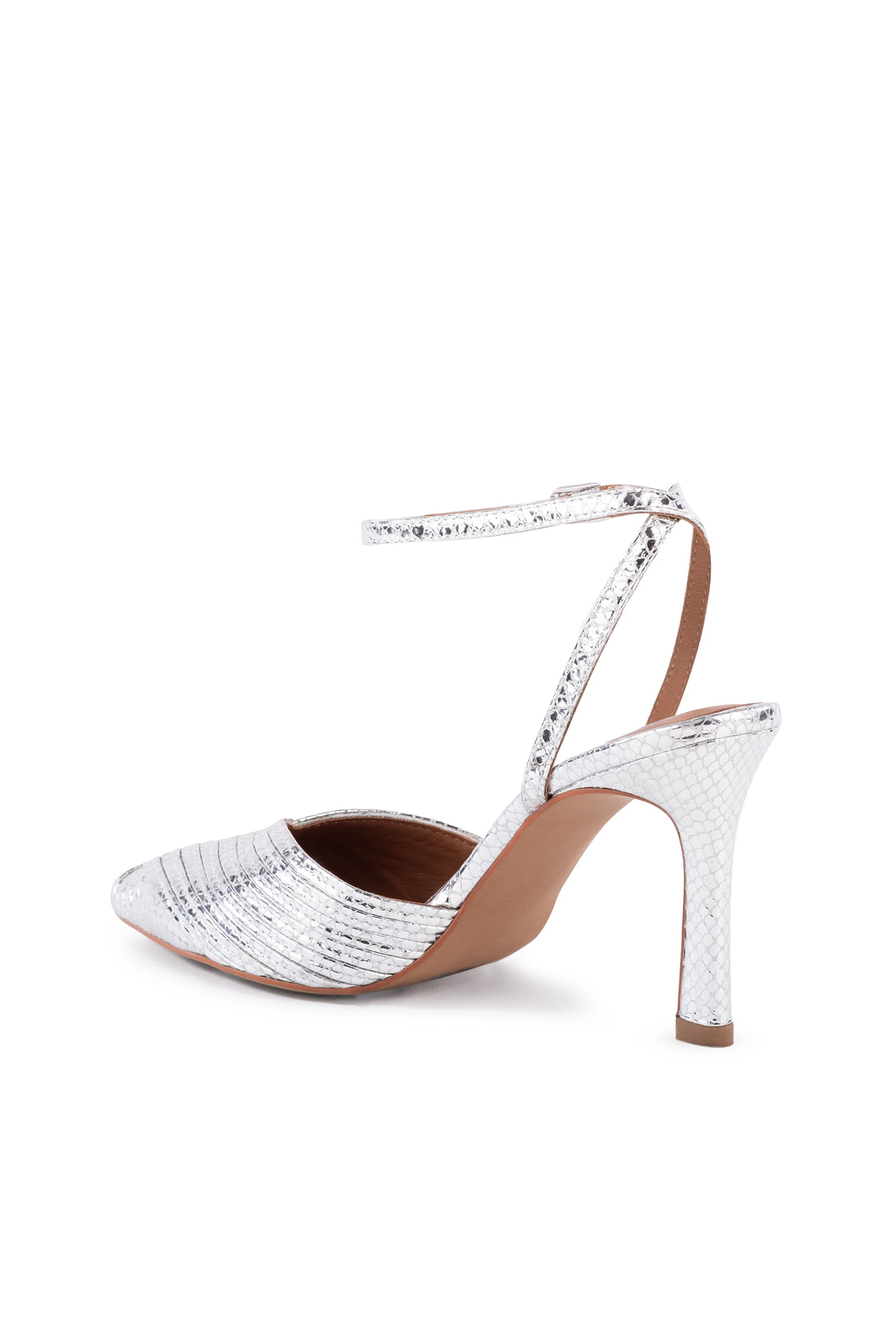 The On To The Next Strappy Silver Heel With Pointed Toe features a metallic snakeskin texture, pointed toe, ankle strap with buckle, slim high heel, and closed back for an elegant modern style.