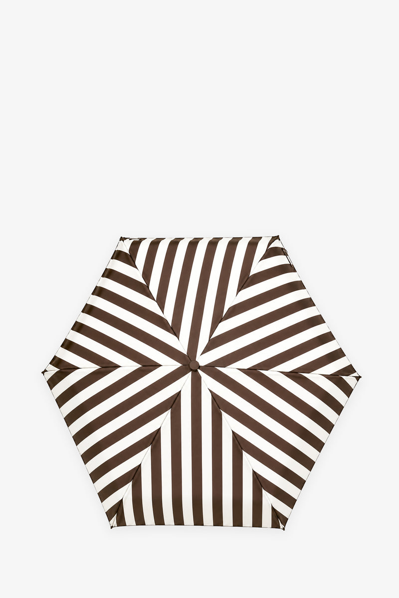 The TT Umbrella features a hexagonal shape with alternating diagonal black and white stripes arranged in a striking geometric pattern, shown from above against a white background.