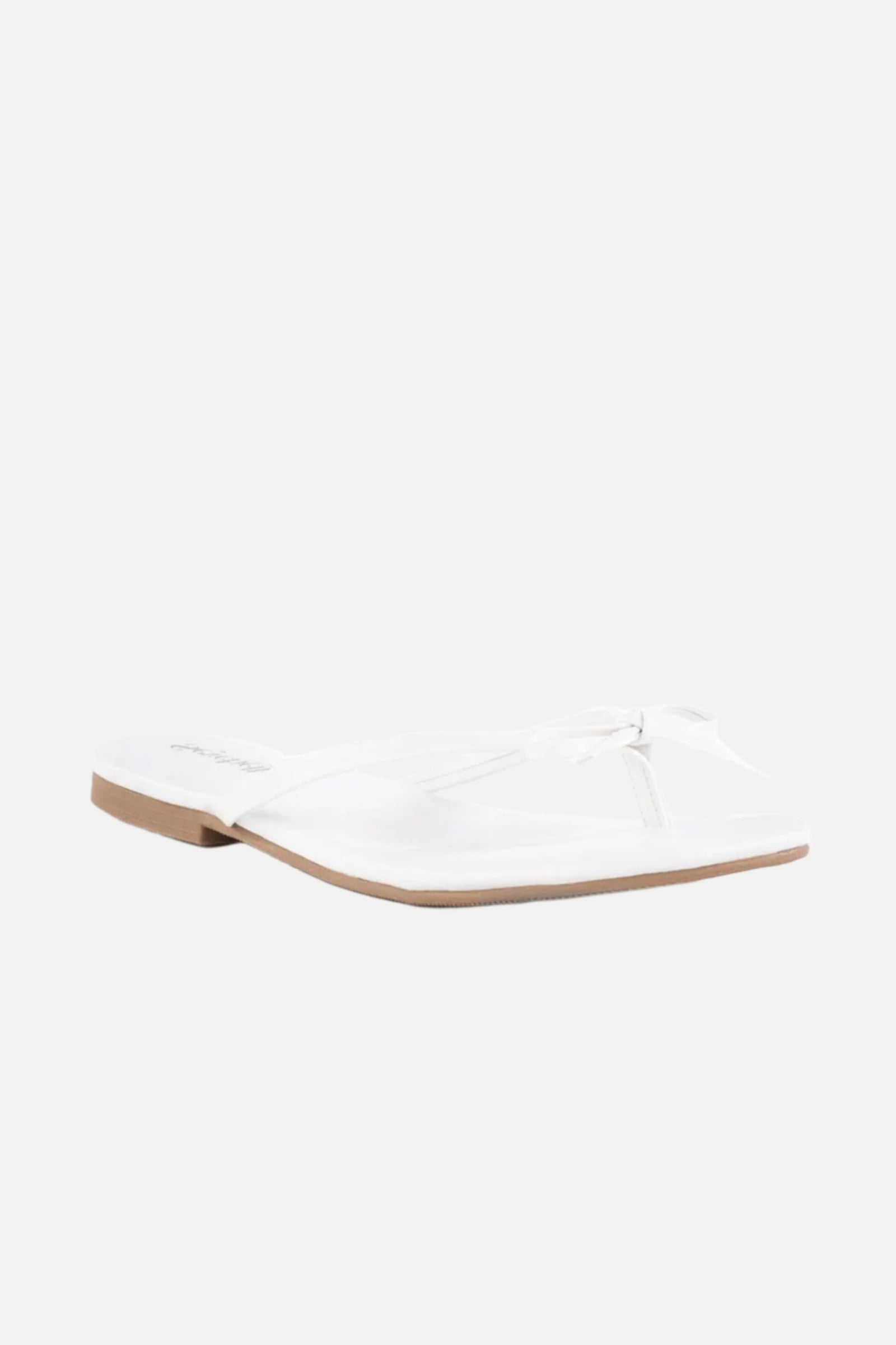 The Wish List Bow Thong Sandal is a white flat sandal featuring thin bow thong straps, a square toe, and a tan sole, shown on a plain white background.