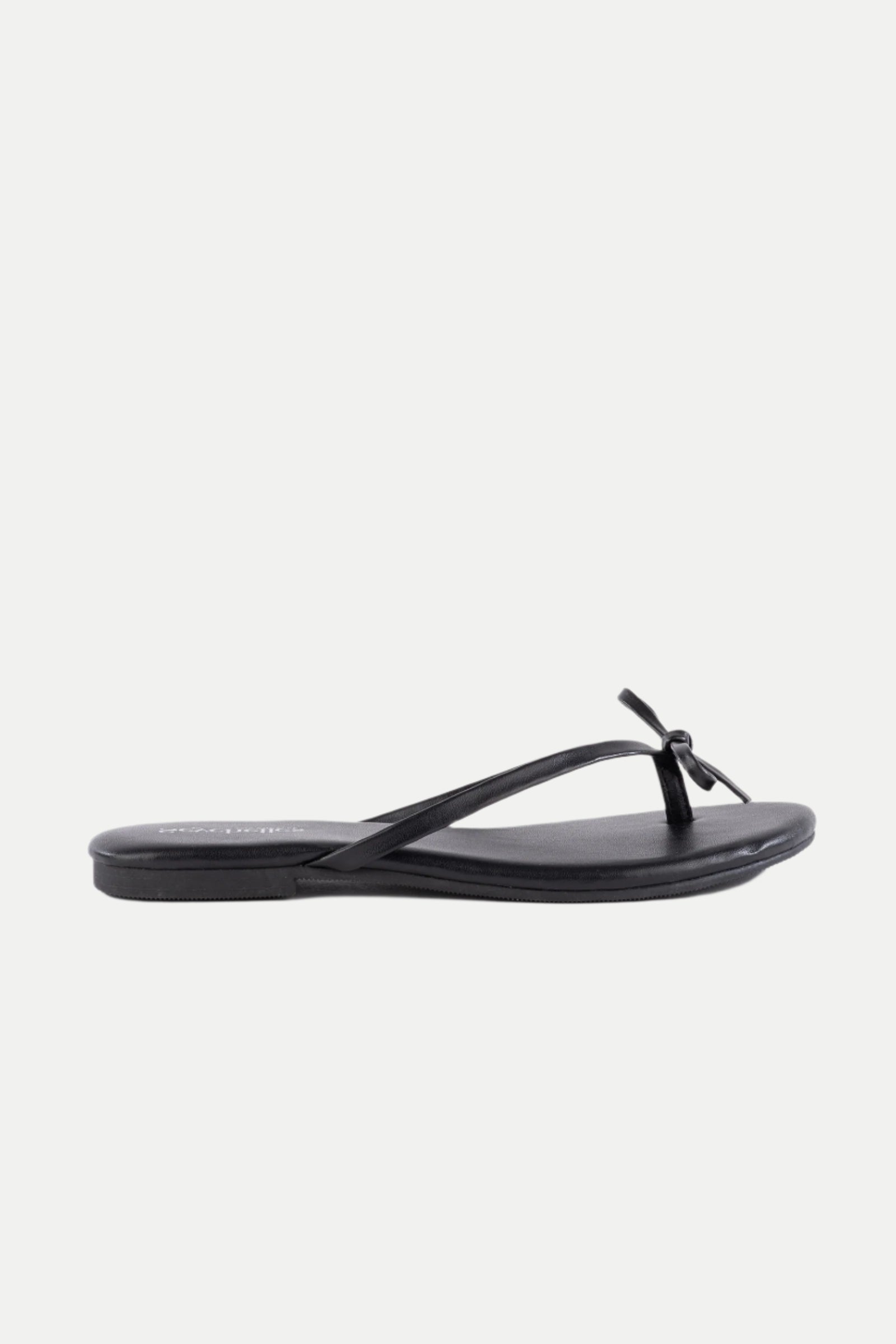 The Wish List Bow Thong Sandal in black features thin straps and a small front bow, displayed in a side profile view against a plain white background.