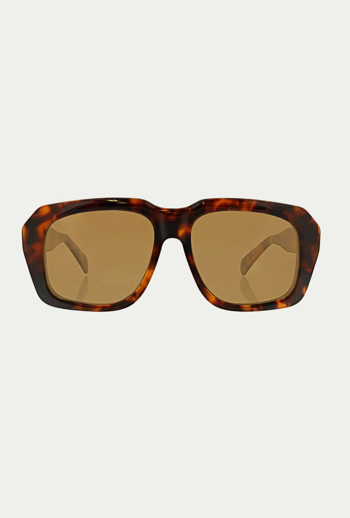The Andros Sunglass features a bold tortoiseshell acetate frame with rectangular brown-tinted lenses, offers 100% UVA/UVB protection, and is displayed against a plain white background.