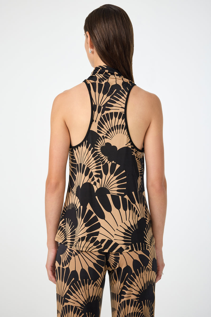 A person with long, straight brown hair wears the Mosiac Cowl Neck Top in Juniper Jersey, paired with matching pants featuring a bold black and beige abstract fan pattern, seen from the back against a plain white background.