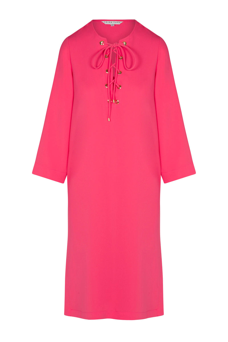 The Catamaran 3/4-Sleeve Midi Dress is a bright pink, knee-length dress with a lace-up neckline featuring gold-tone beads and three-quarter sleeves. It has a relaxed, straight silhouette for effortless style.
