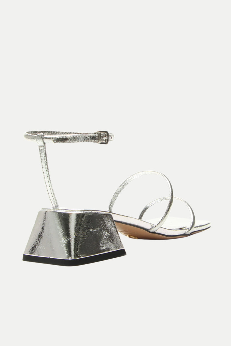The Burano Silver Strappy Heeled Sandal features a low, wide block heel and an ankle strap with buckle, shown on a white background.