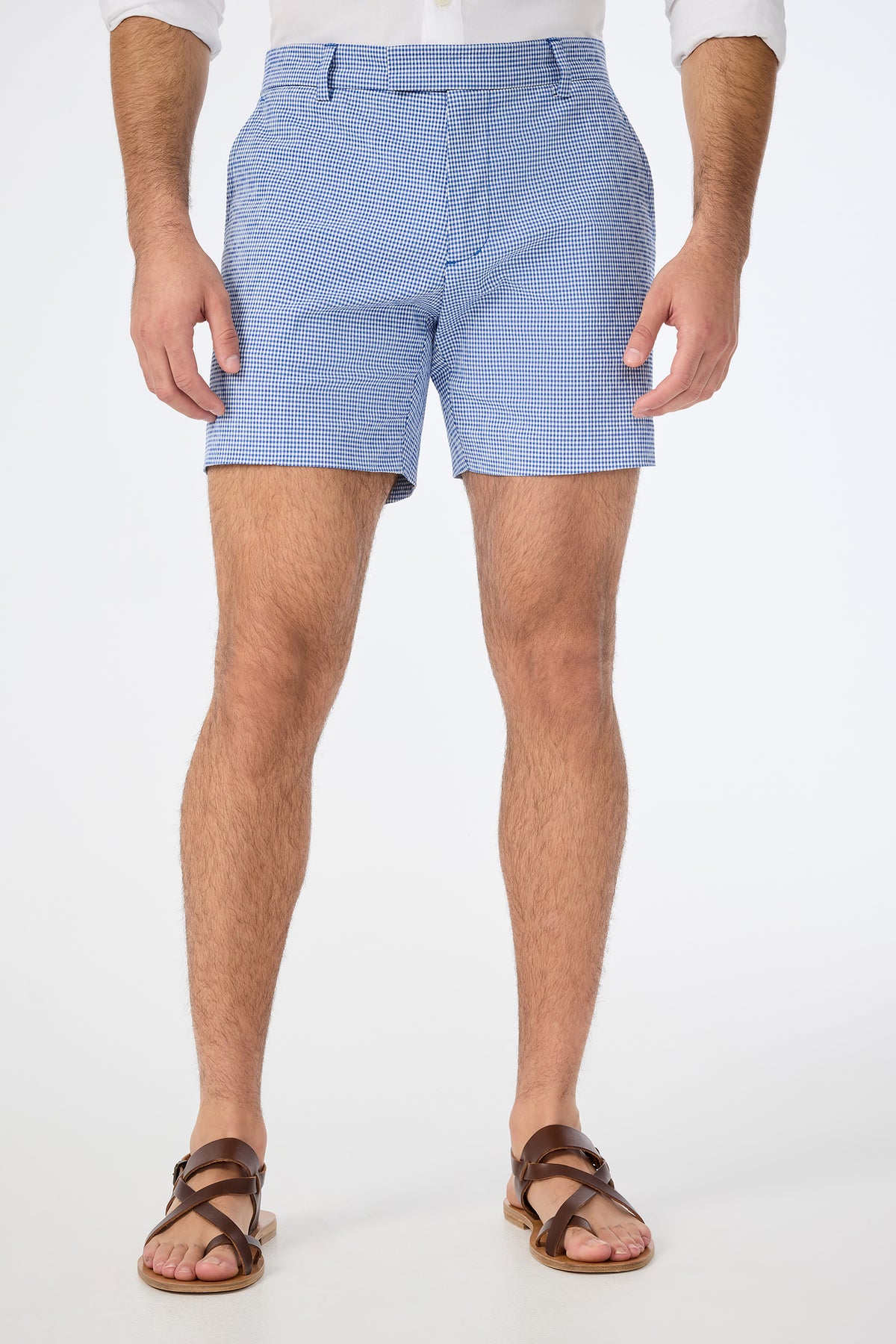 A man stands against a white background, wearing the Roger Short in Ocean Gingham. The image is cropped just below his shoulders to highlight the shorts and legs.