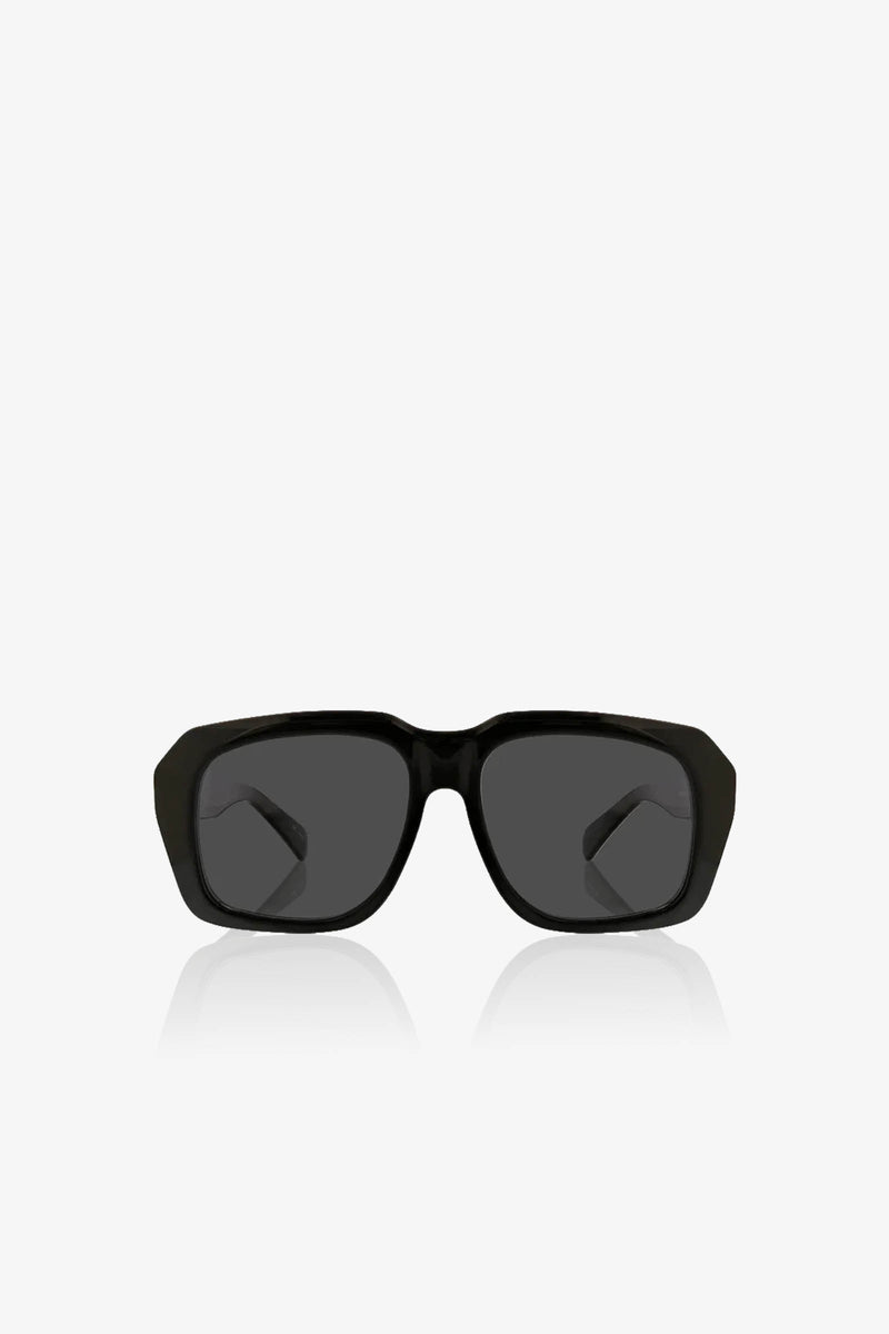 The Andros Sunglass, featuring a black rectangular frame with dark lenses, is centered on a plain white background and shown from the front, with its arms slightly visible behind the lenses.