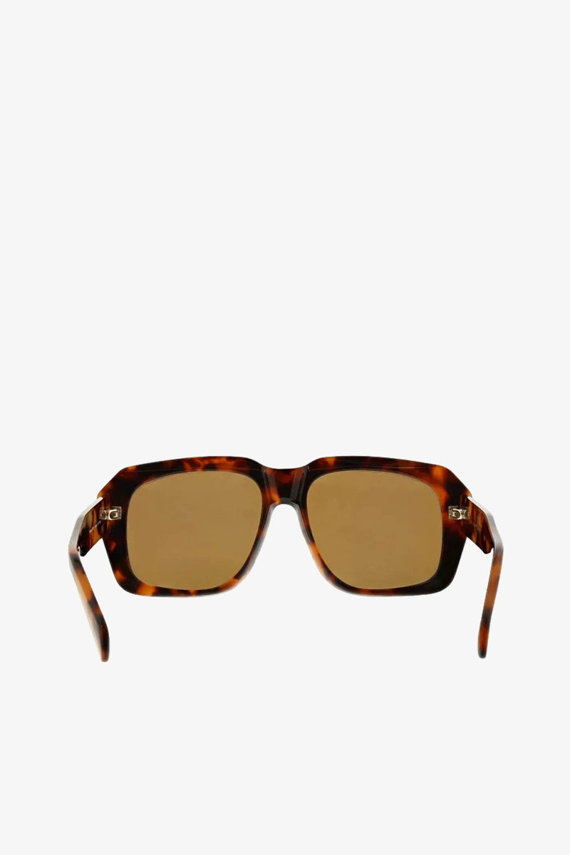 Andros Sunglass: Rectangular tortoiseshell frames with brown lenses, displayed on a plain white background. The arms of the sunglasses are gently angled outward.