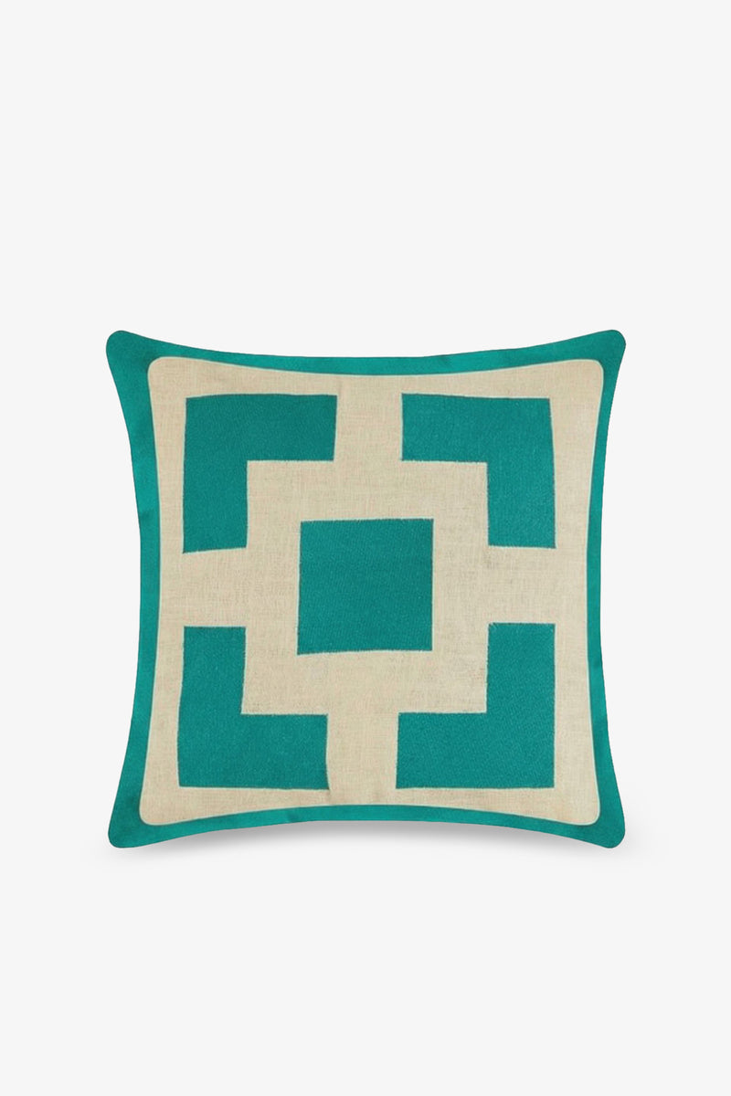 Palm Springs Block Embroidered Square Pillow features a geometric pattern in teal and beige on a white background, highlighted by a central square surrounded by angular shapes. This designer pillow includes a teal border and adds sophisticated flair to any space.