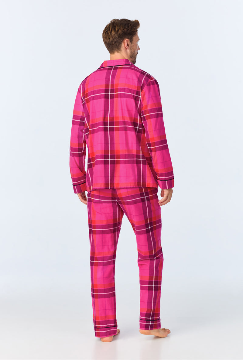 A man stands barefoot, back to the camera, wearing the Aurora Plaid Mens Long Sleeve Long Pant Flannel PJ Set in bright pink and purple against a plain light background.