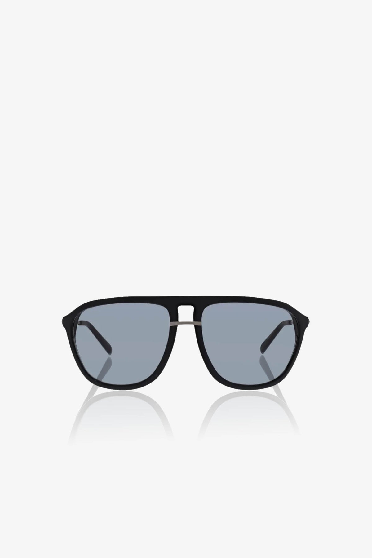 The Stern Sunglass features black aviator frames with oversized blue tinted lenses, showcased against a white background. Combining style and comfort, these sunglasses provide reliable UV protection.