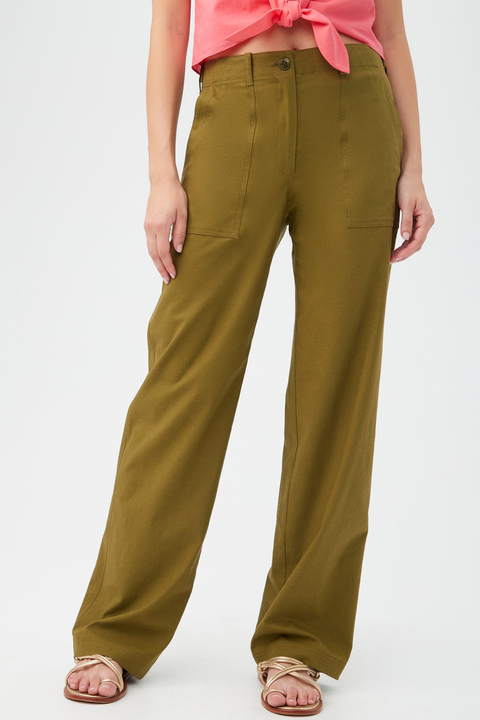 A pair of beige capri pants presented against a white background, with the brand logo visible on a tag on the waistband.