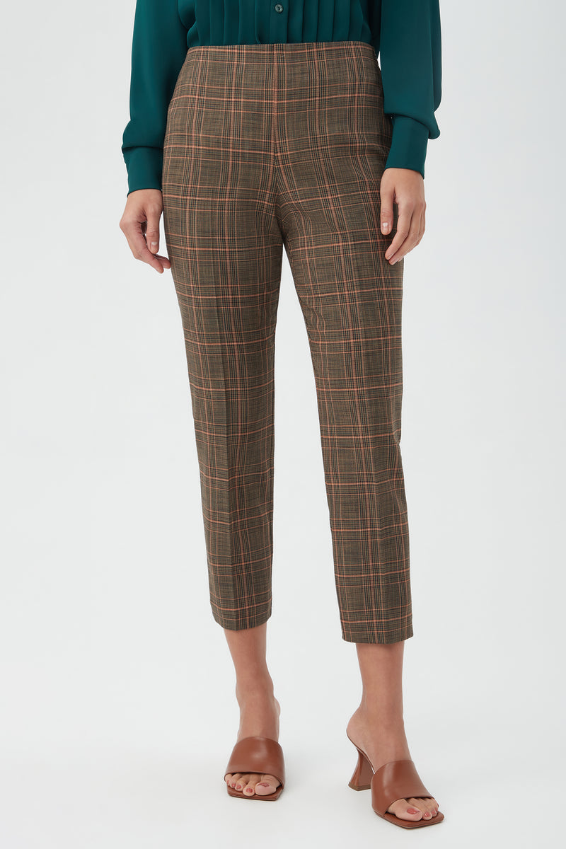 A person wears the Masego Pant in Multi with a dark green long-sleeve shirt and brown heeled sandals, standing against a plain light background. The face is not visible.