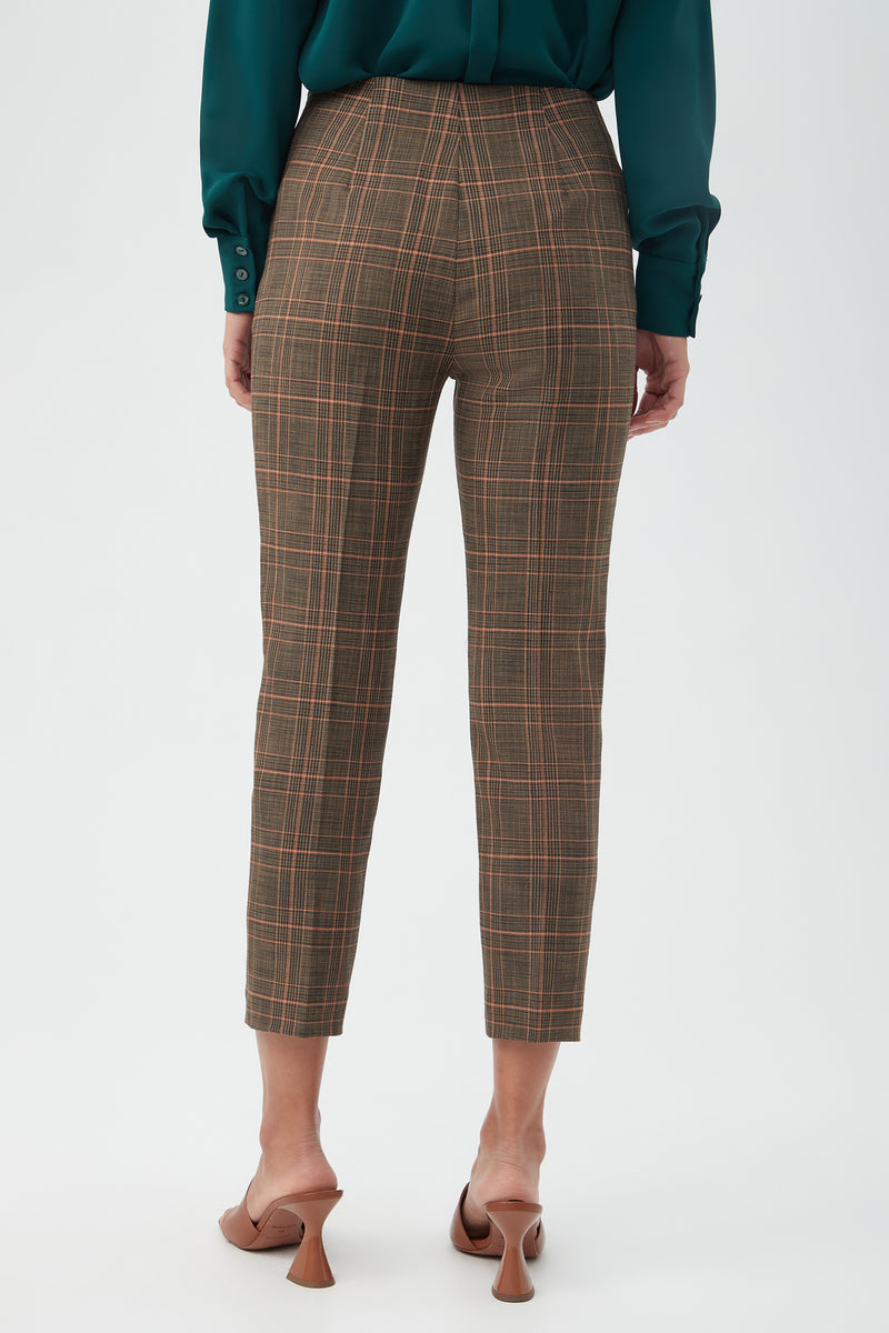 Model shown from the back wearing the Masego Pant in brown plaid, paired with a dark green long-sleeve blouse and tan heeled sandals against a plain light background.
