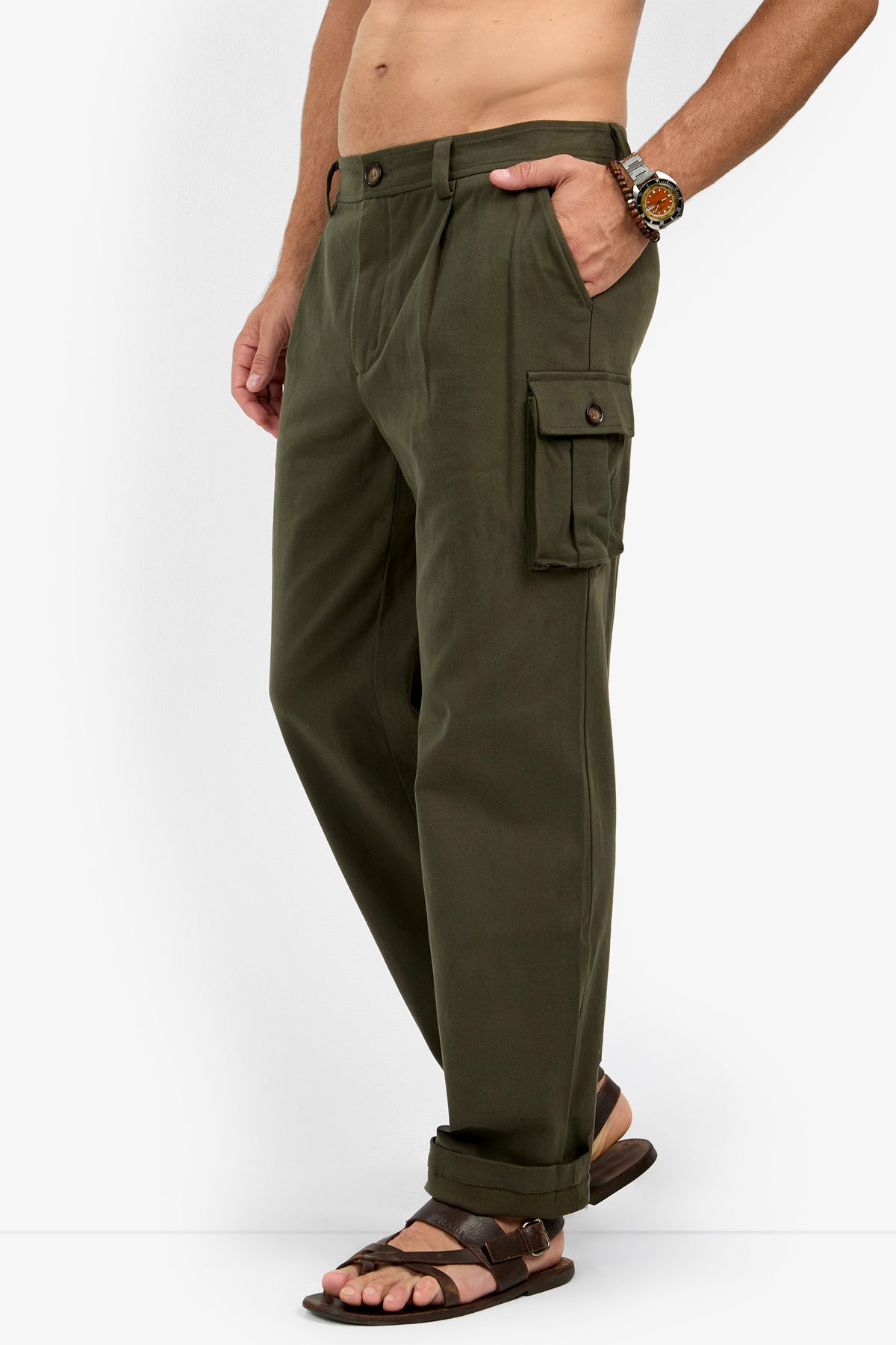 A person is shown from the waist down wearing Lincoln Heights Cargo Trouser - Brushed Twill, brown sandals, and a beaded watch against a white background.