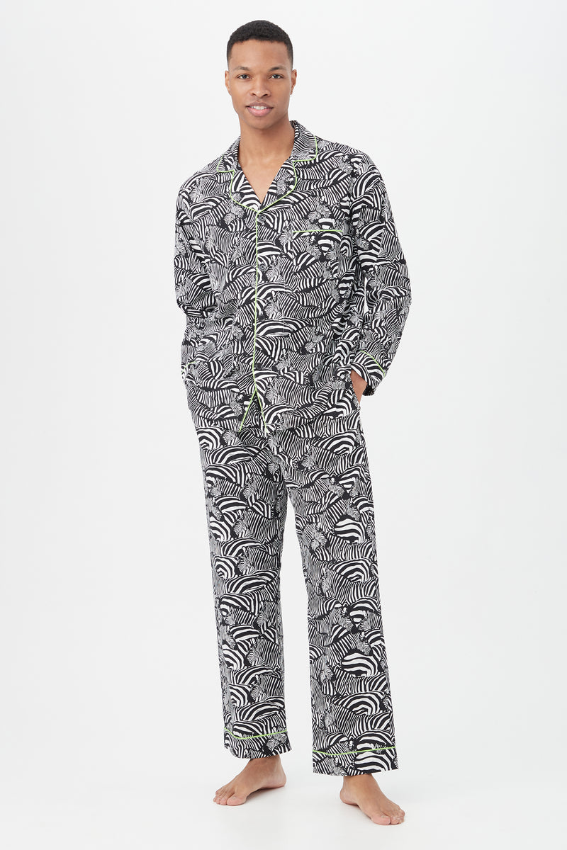 A person stands barefoot in the Zebra Safari Mens Long Sleeve Long Pant Poplin PJ Set in black/white, posing against a plain white background.