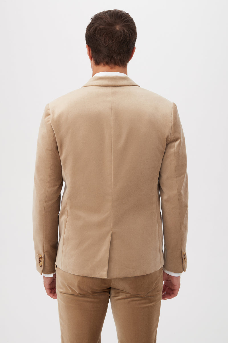 A man wearing the Thurston Blazer in gold velveteen stands with his back to the camera against a plain white background.