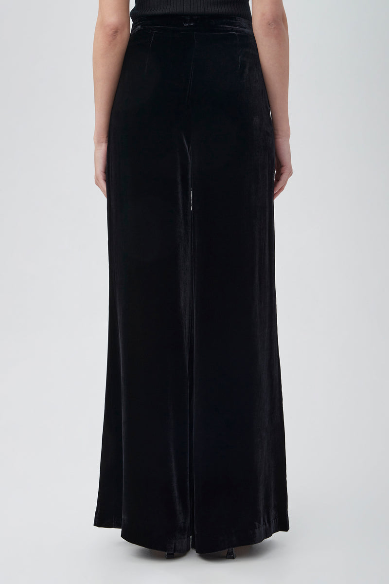 A person is shown from the back wearing Saige Velvet Wide Leg Pants in black, standing against a plain light gray background.