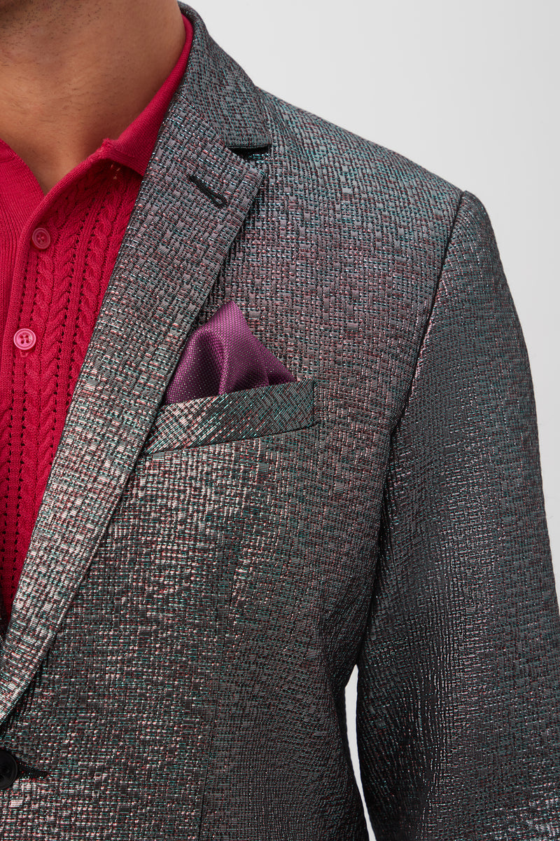 A close-up of a person wearing the Thurston Blazer in Mini Stained Glass Jacquard with a purple pocket square over a red collared knit shirt, showing only the neck, shoulder, and part of the chest.
