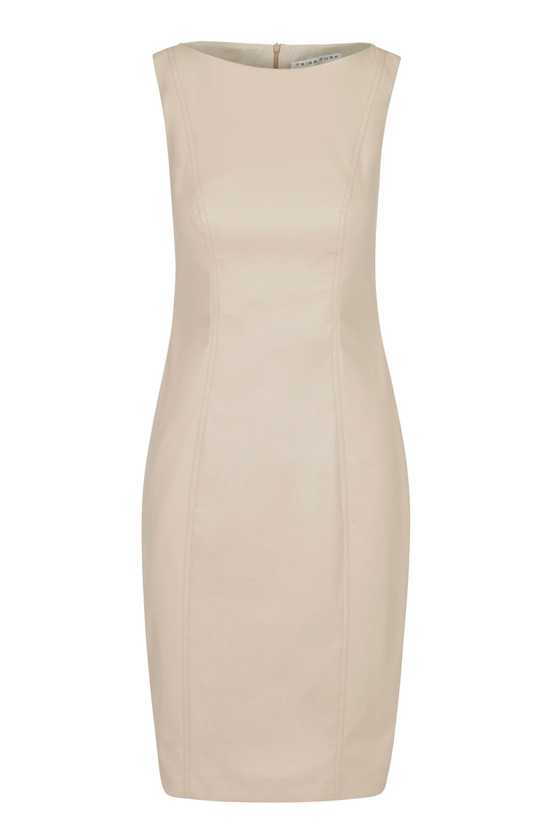 The Emerson Dress is a sleeveless, fitted beige dress featuring a high neckline, subtle front seam detailing, and a knee-length, elegant design.