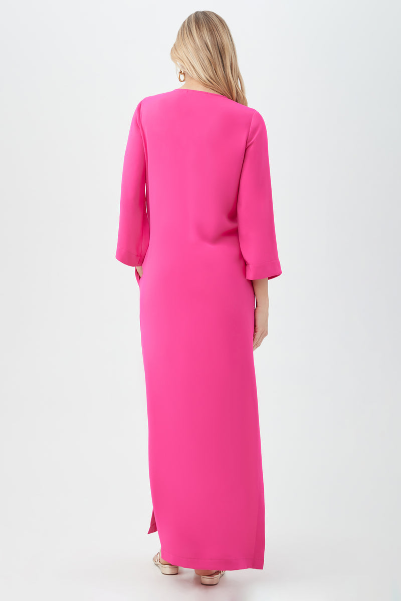 A woman with long blonde hair, seen from behind, wears the Catamaran 3/4-Sleeve Maxi Dress in bright pink and sandals, posed against a plain white background.