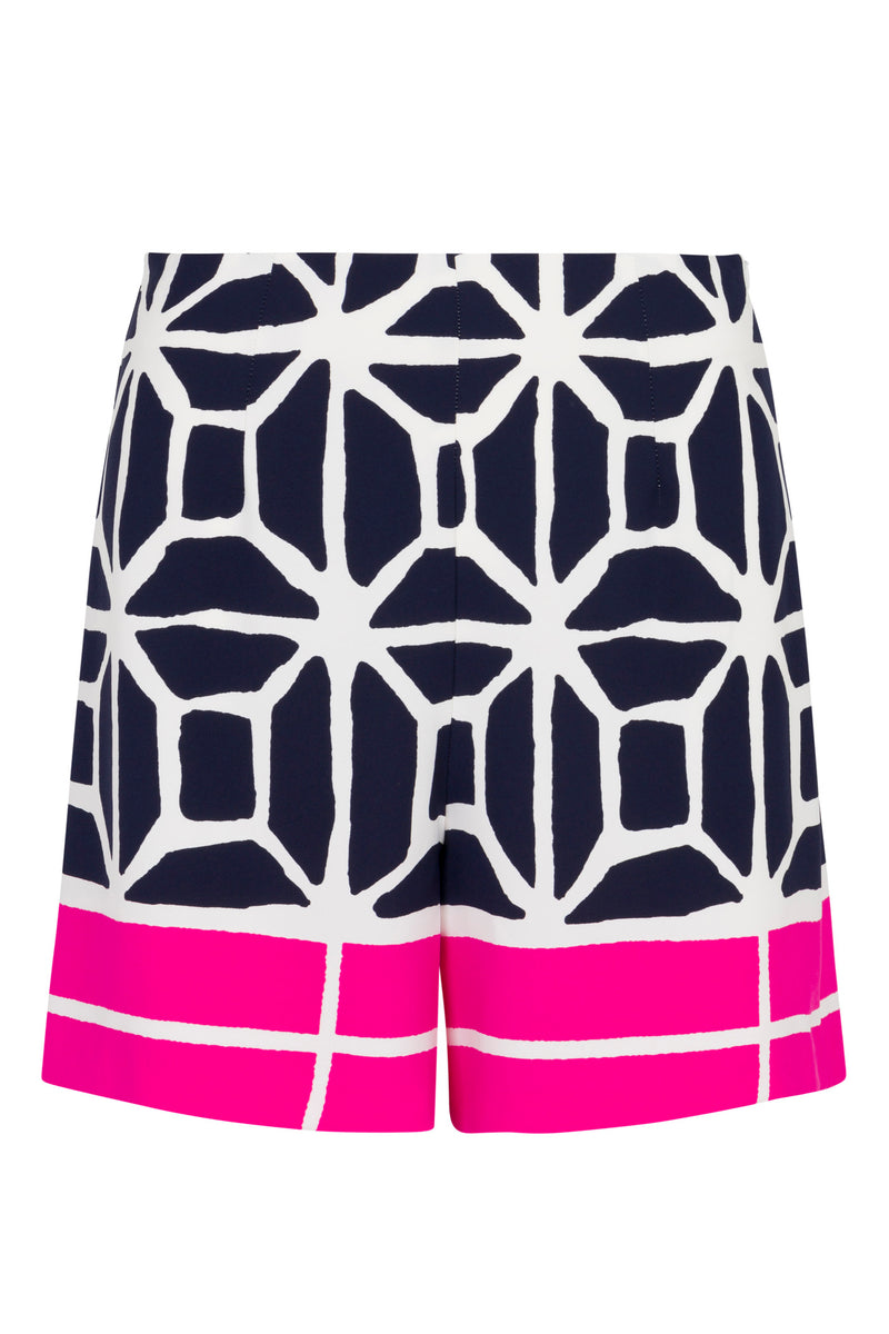 The Shalyn Shorts - Durell Georgette feature a navy blue and white geometric pattern with a bold hot pink and white graphic border at the hem and intersecting lines that create abstract shapes.
