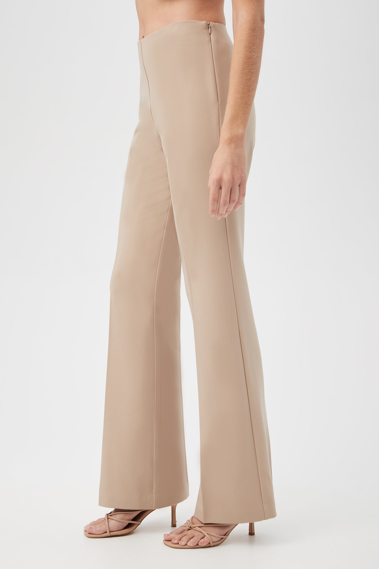 A person wearing Jacoba Slim-Fit Stretch Bootcut Pants and beige heeled sandals, shown from the side against a plain white background.