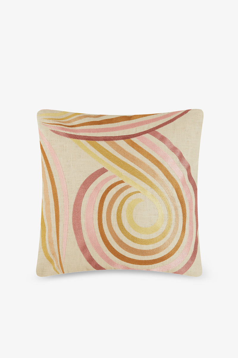 The Calexico Embroidered Square Pillow features a beige base with abstract wavy spirals in pink, gold, orange, and brown, filled with plush down feathers for a retro-modern look inspired by TRINA TURK HOME.