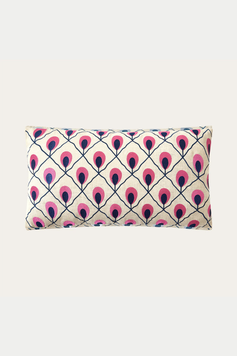 The Roseville Embroidered Throw Pillow - Multi features a cream background with a repeating diamond grid of stylized pink and dark blue peacock feathers.