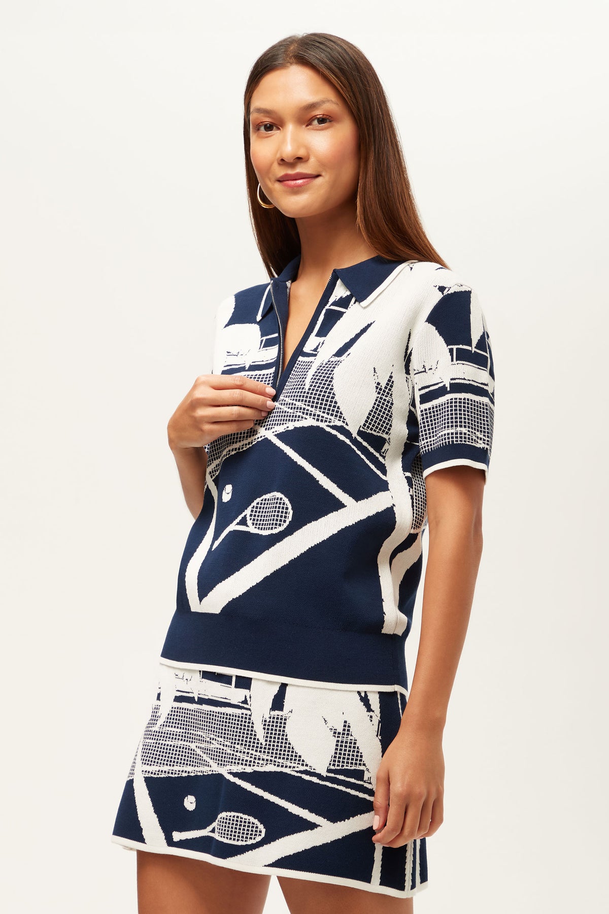 A woman wears the La Jolla 2 Short-Sleeve Graphic Knit Polo in ink.