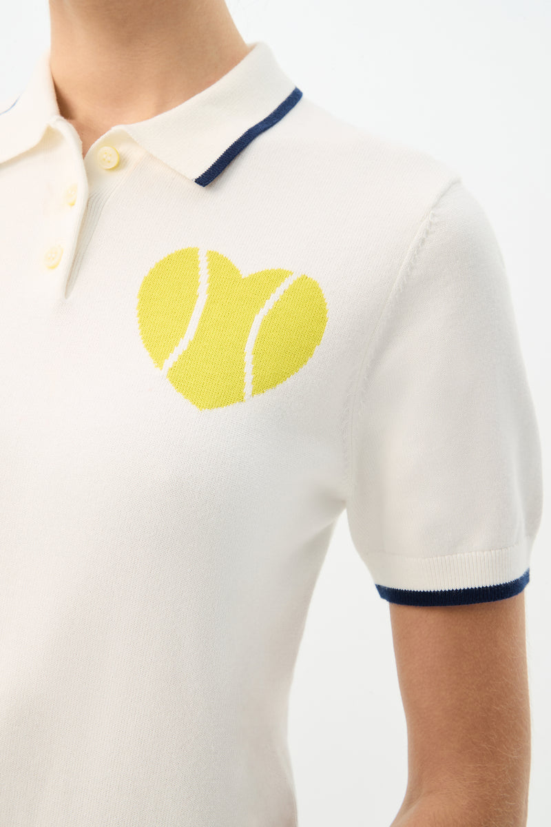 A close-up of the Serena Tennis Heart Short-Sleeve Polo featuring a tennis ball design on a white shirt.