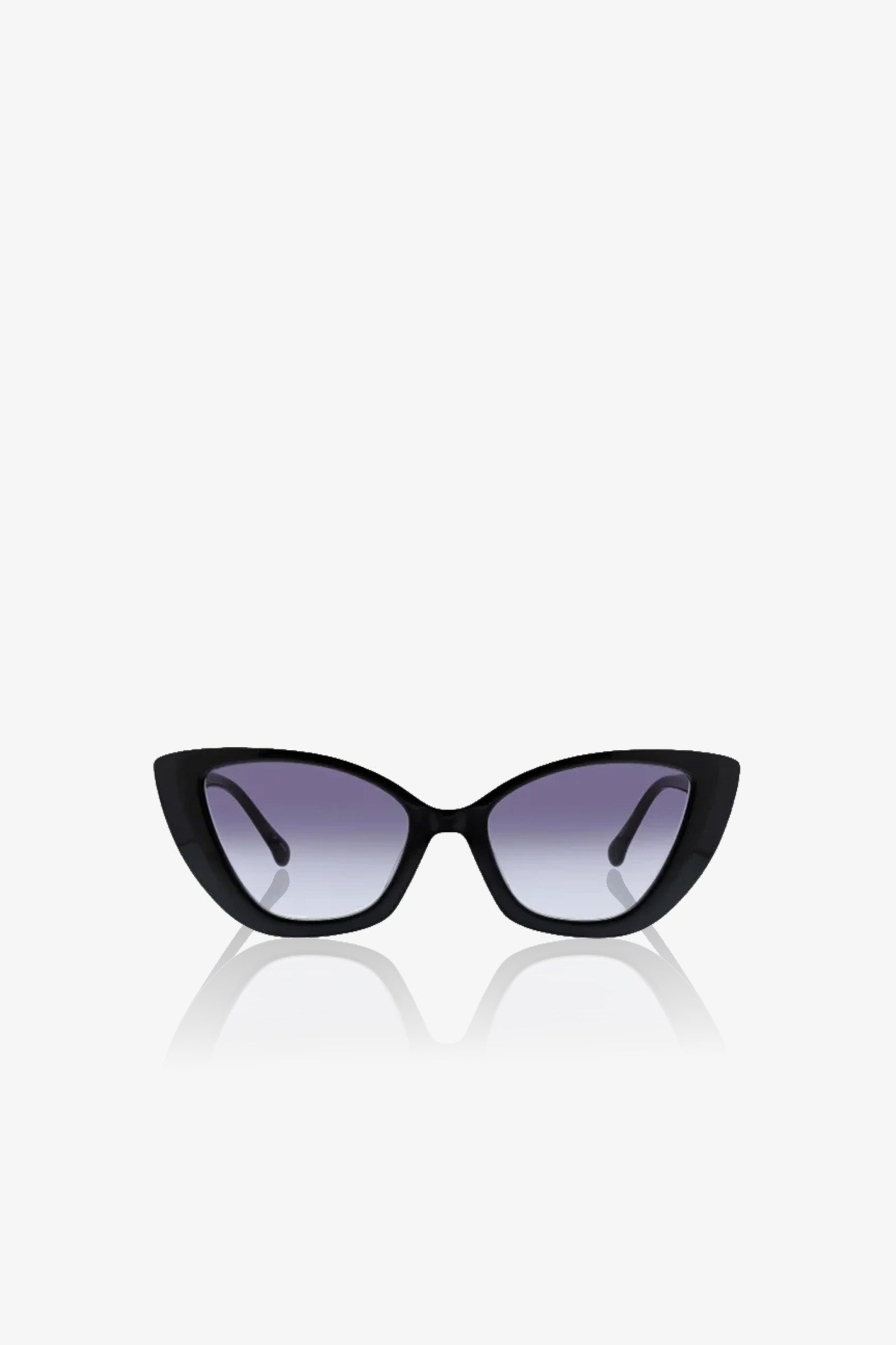 Tenerife Cat Eye Acetate Sunglasses with dark gradient lenses, displayed on a white background. The sleek arms curve inward, and a subtle reflection appears beneath them.