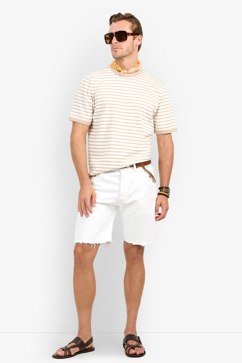 A man wears the Giovanni Stripe Short-Sleeve Pullover with white cut-off shorts, brown sandals, sunglasses, a yellow neck scarf, and bracelets while standing against a plain background.