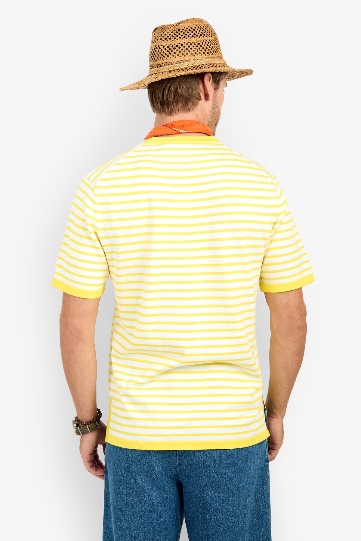 A man in a straw hat, orange bandana, blue jeans, watch, and Giovanni Stripe Short-Sleeve Pullover stands with his back to the camera against a plain white background.