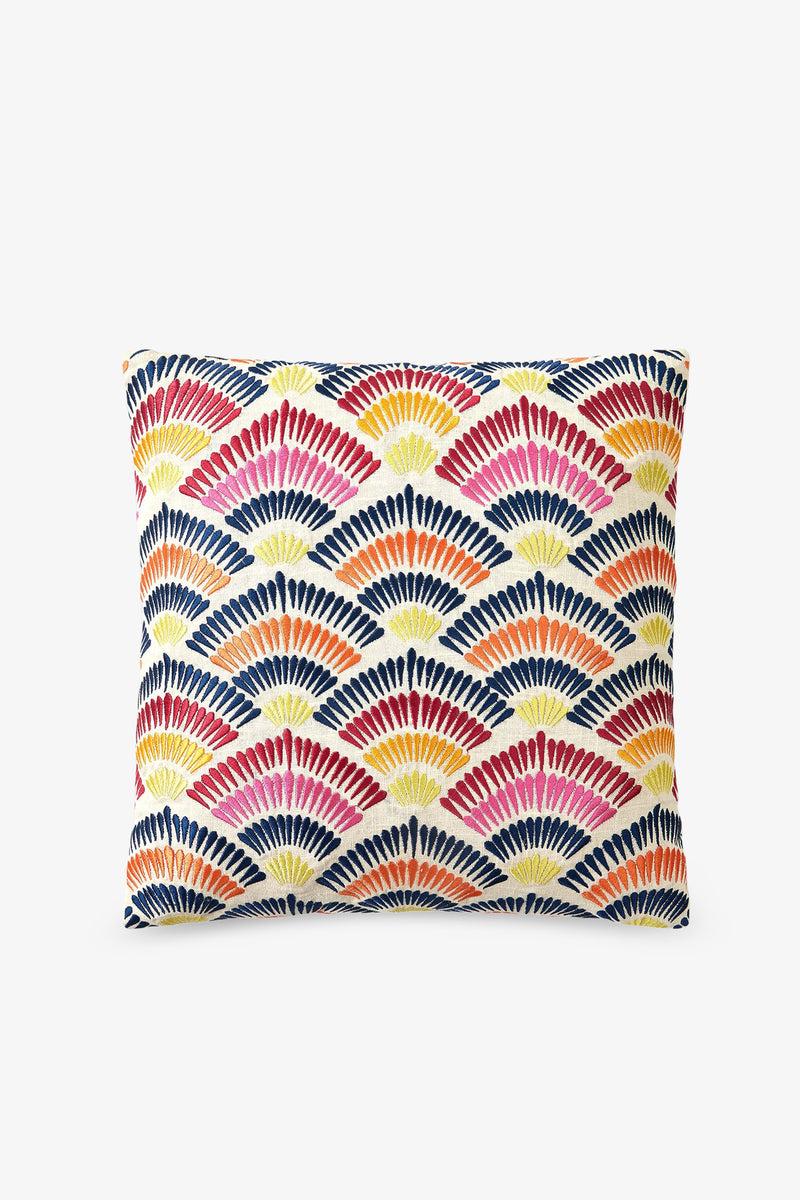 The Embroidered Square Pillow features a geometric fan pattern in red, orange, yellow, and navy blue on a white background.