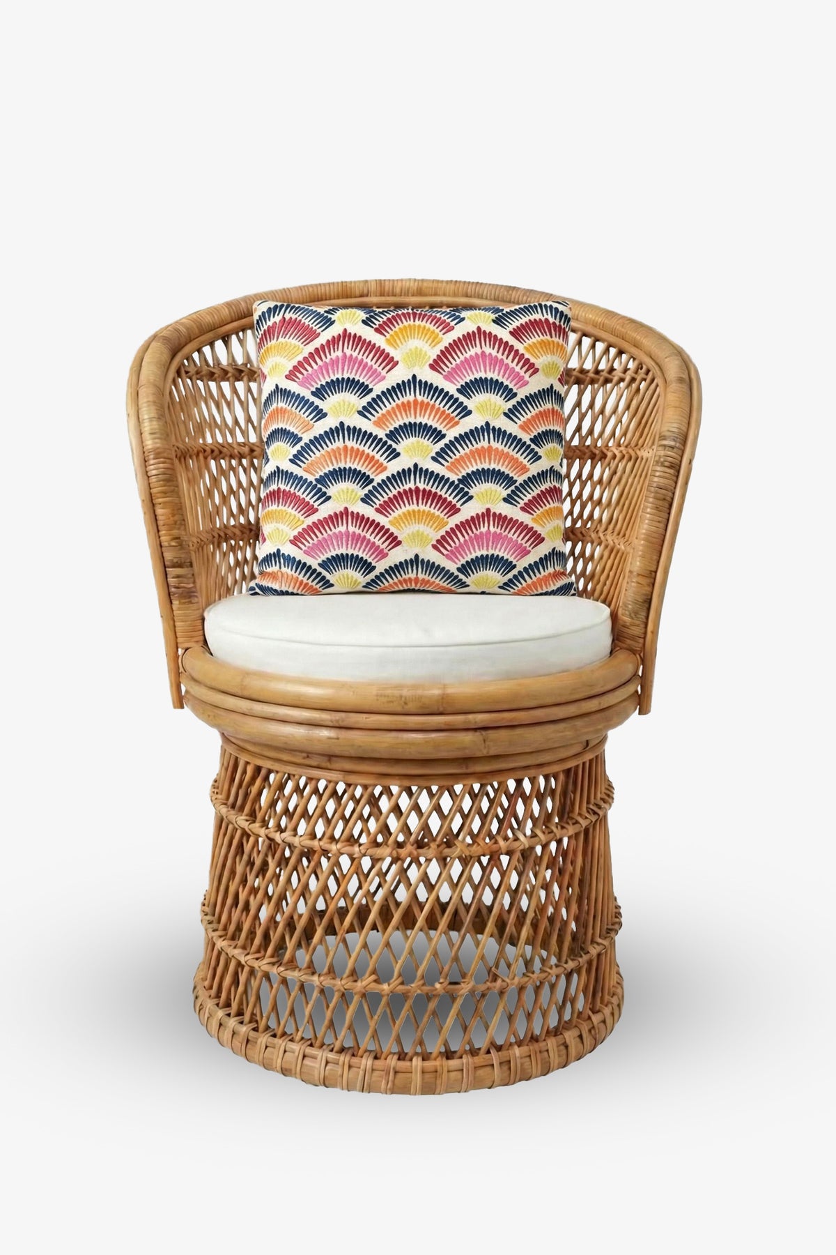 A round rattan chair with a white cushion and an Embroidered Square Pillow featuring colorful blue, red, and yellow semicircle designs, set against a plain white background.