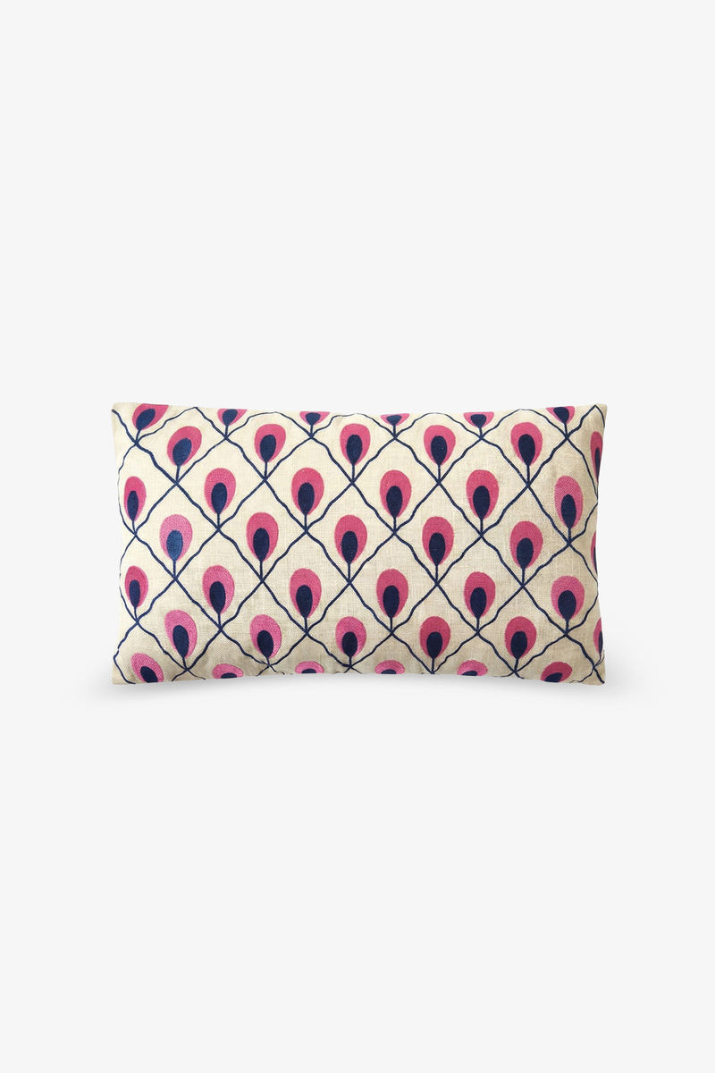 Embroidered Lumbar Pillow featuring a symmetrical pattern of repeating pink and navy blue peacock feathers on a cream background, with the feathers aligned in rows and connected by navy blue lines.