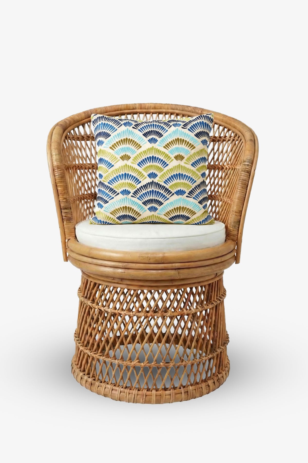 A round wicker chair with a curved backrest and a white seat cushion, featuring the Pasadena Embroidered Square Pillow adorned with a blue, yellow, and green geometric fan pattern. The background is plain white.