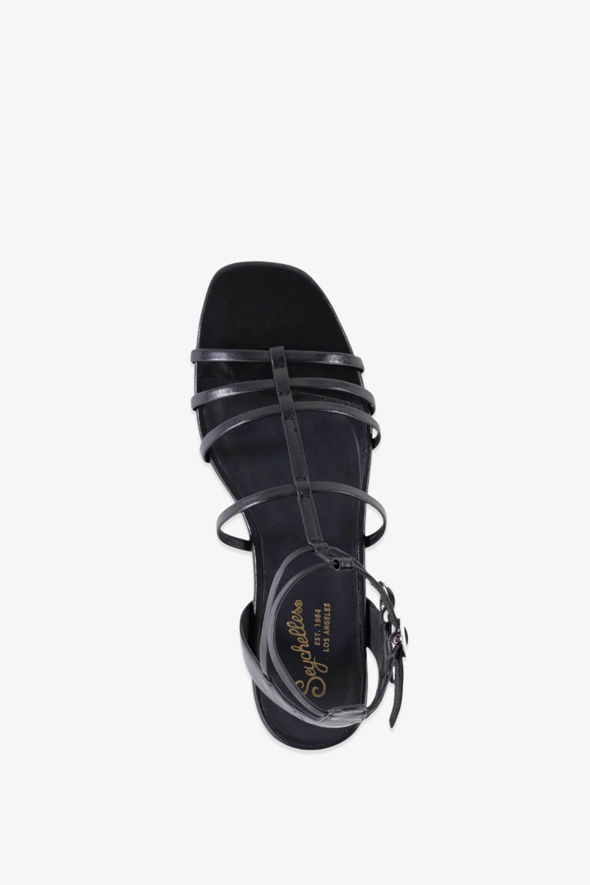 Top view of a single Luxurious Wedge Sandal in black leather, featuring strappy design with a buckle ankle strap and gold Splendid branding on the insole, displayed on a plain white background.