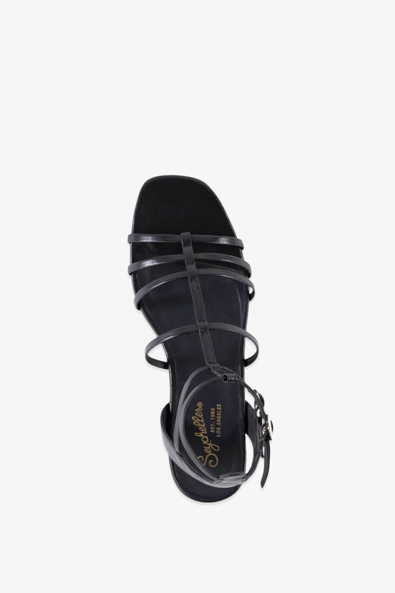Top view of a single Luxurious Wedge Sandal in black leather, featuring strappy design with a buckle ankle strap and gold Splendid branding on the insole, displayed on a plain white background.