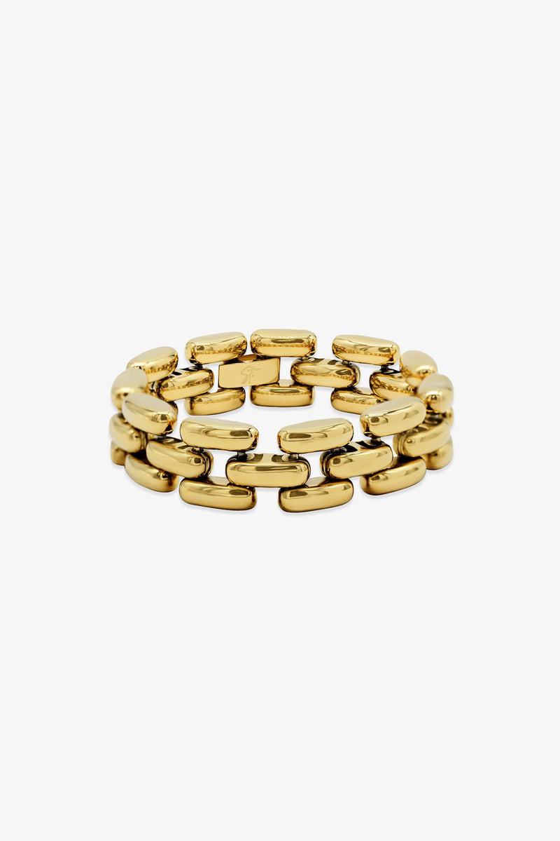 The Phoebe Bracelet features a gold-tone, chunky chain-link design with rectangular, interlocking links arranged in three rows, displayed against a white background.
